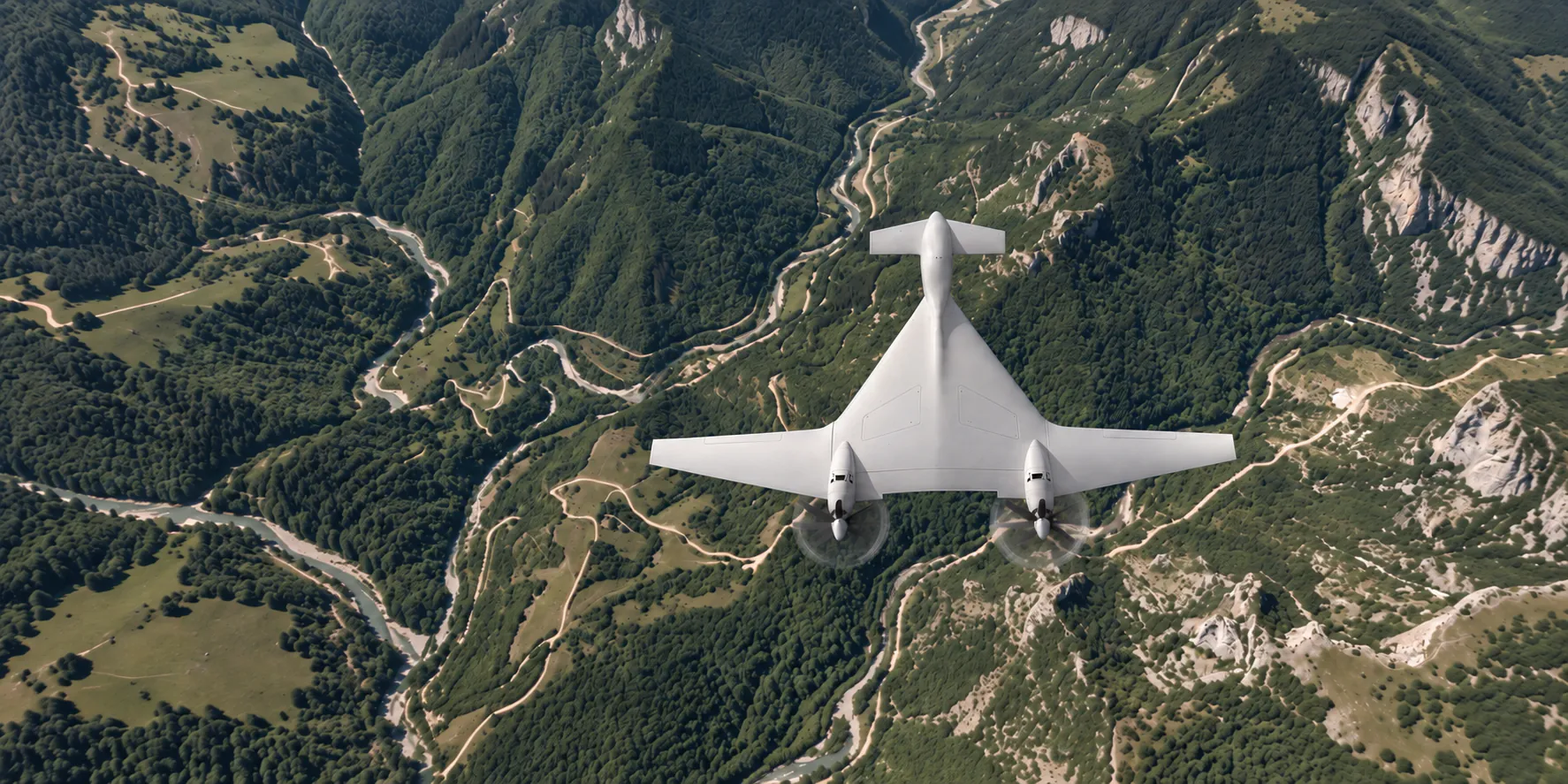 UAV flying above a forested mountain valley